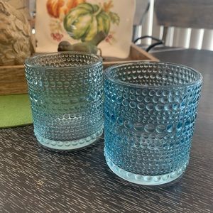 Two light blue glass candle votive’s